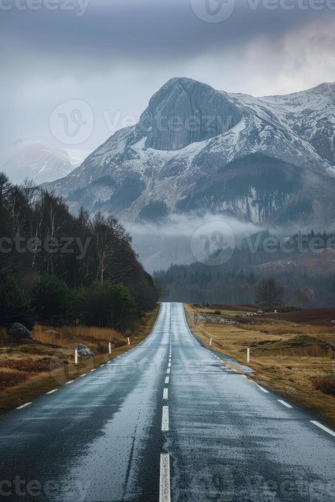 Journey Towards Mountain Peaks Along an Empty Road photo