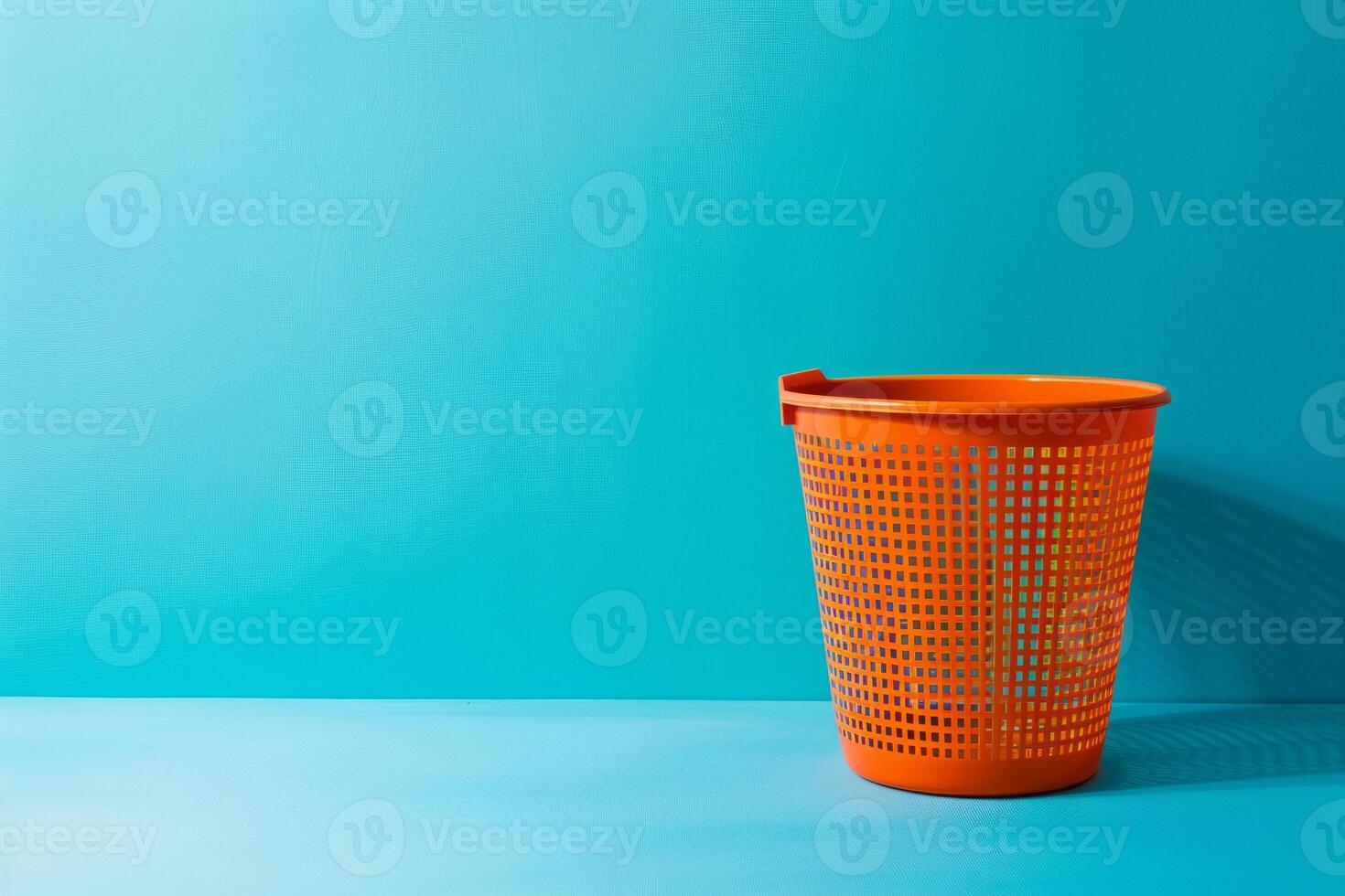 Waste basket for paper on blue background photo