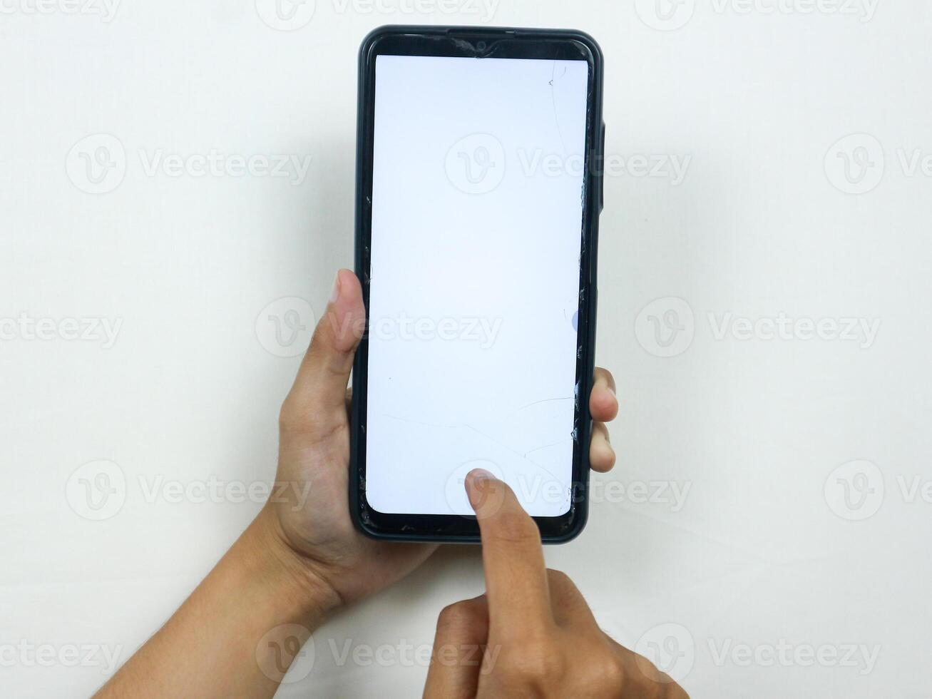 Hands of businesswoman holding smart phone with blank screen at loft office photo