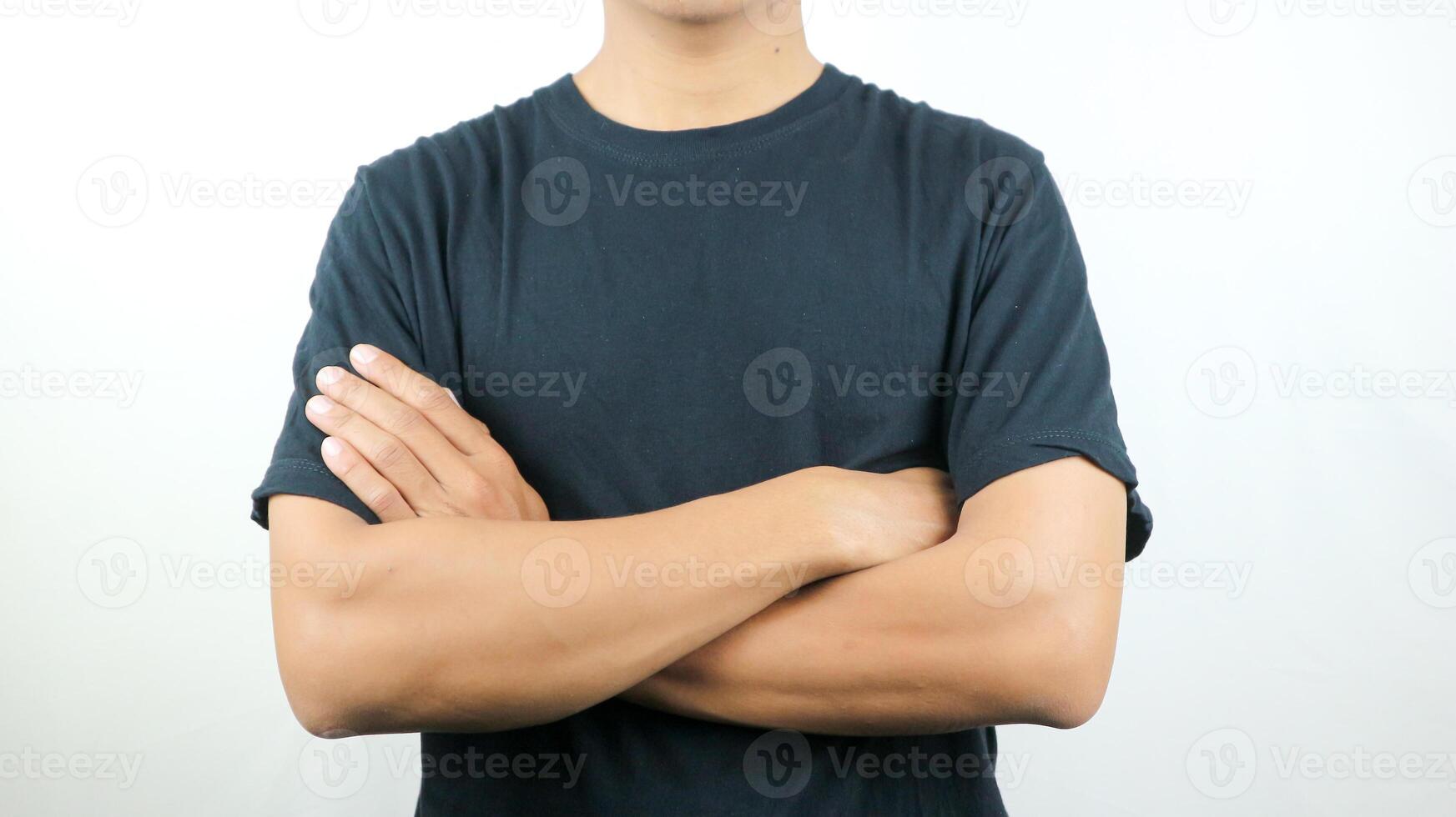 man athlete, bodybuilder in black t-shirt with arms crossed on the body on the white background photo