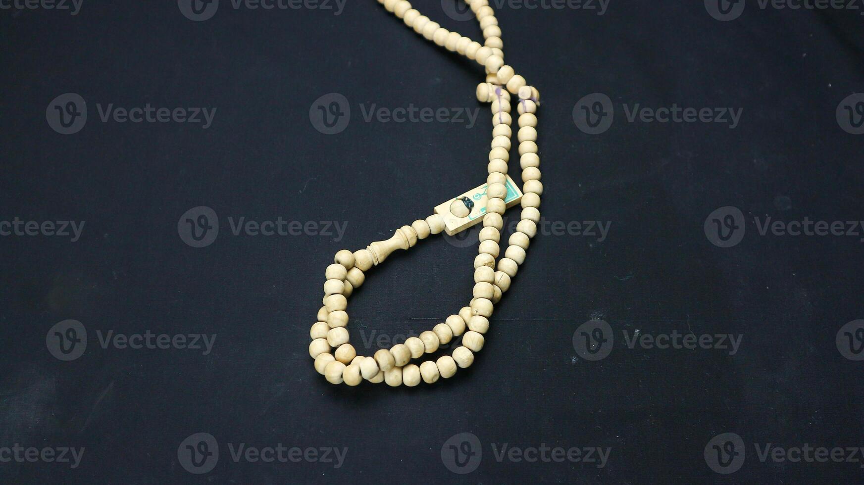 Wooden prayer beads on black background. photo