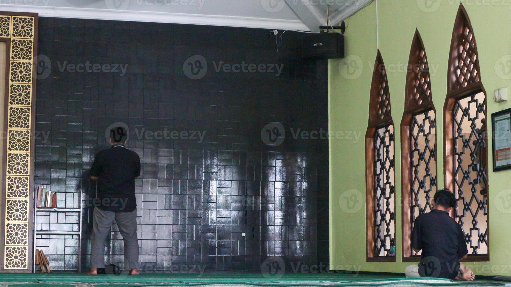 Muslim man praying in the mosque photo