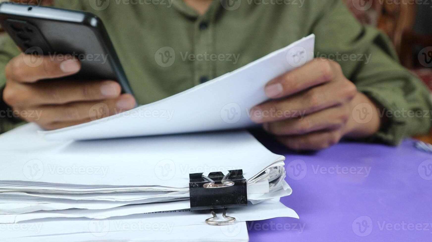 Businessman Preparing reports papers. Piles of unfinished document achieves with paper clip. photo