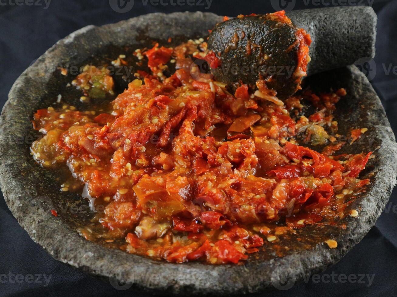 Indonesian traditional chili sauce named sambal terasi or sambal ulek crushed on mortar photo