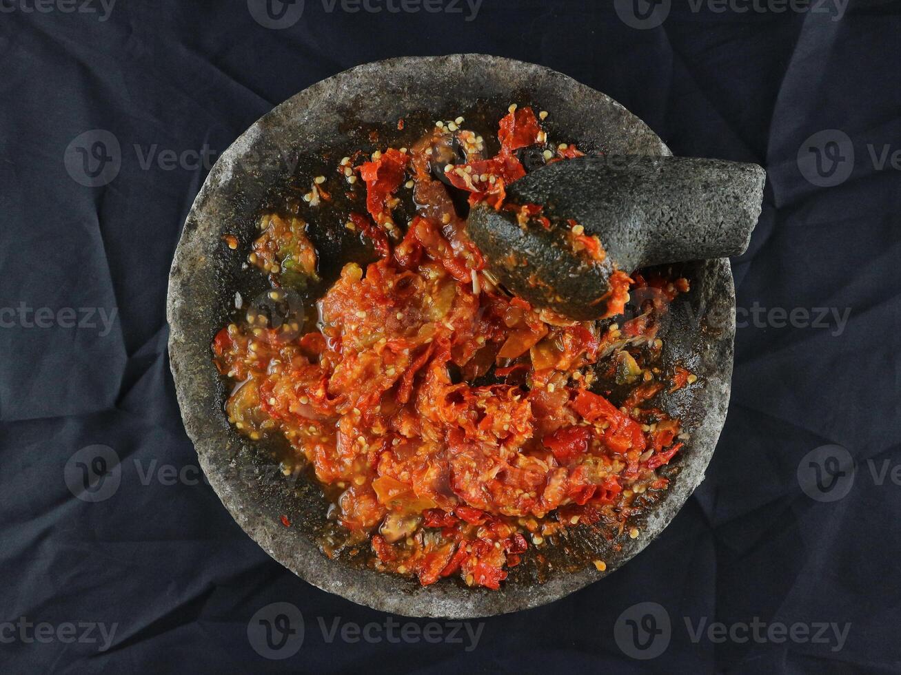 Indonesian traditional chili sauce named sambal terasi or sambal ulek crushed on mortar photo