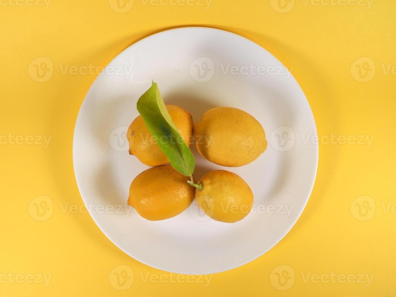 lemons in a dish flat view photo