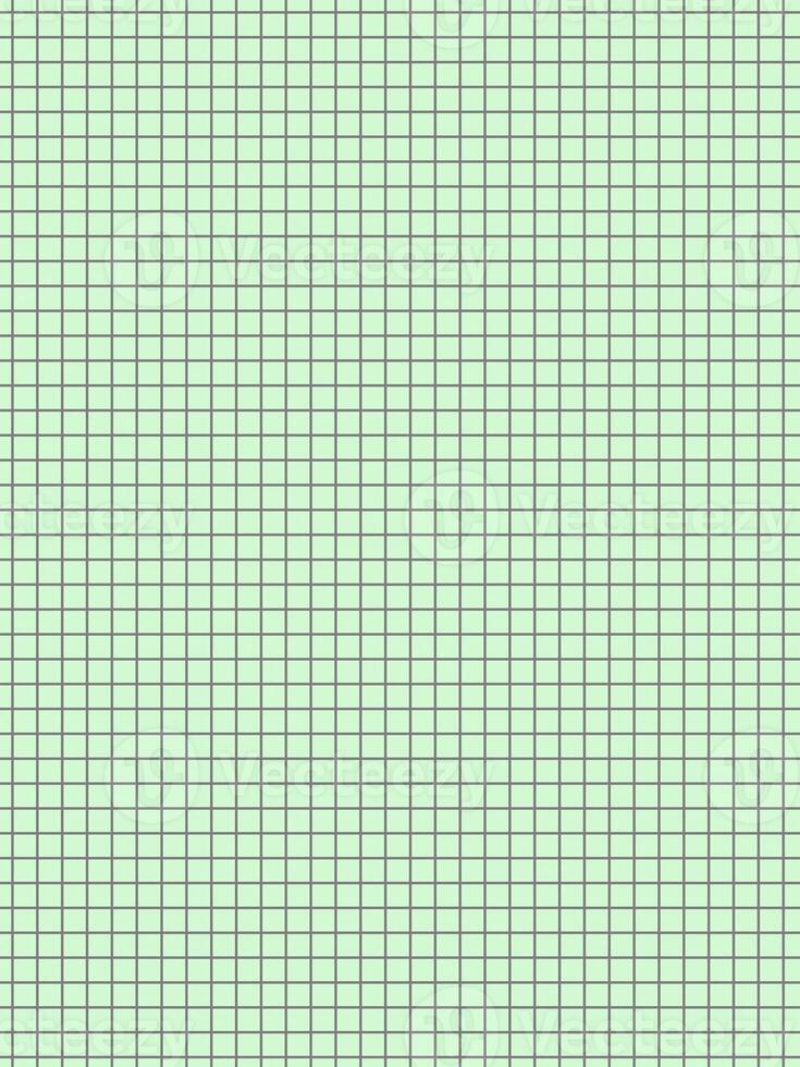 black color graph paper over green background photo