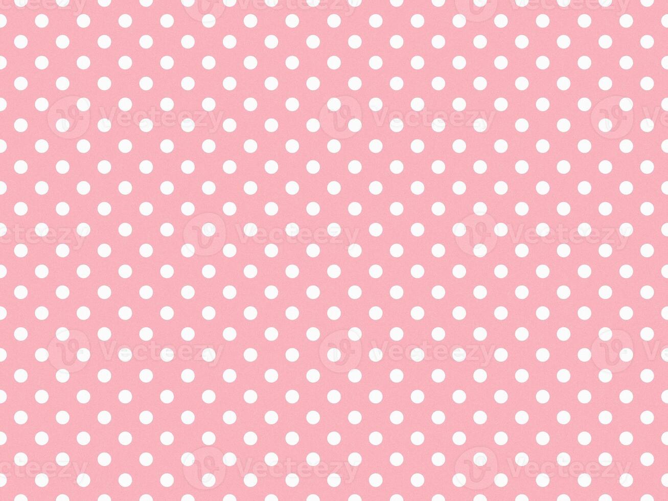 texturised white color polka dots over light pink background photo