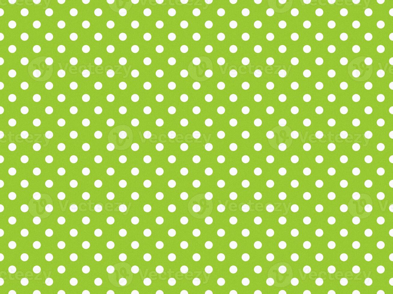 texturised white color polka dots over yellow green background photo