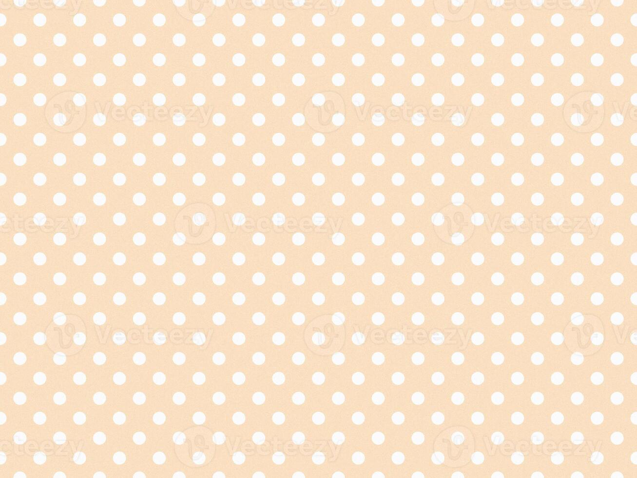 texturised white color polka dots over bisque brown background photo