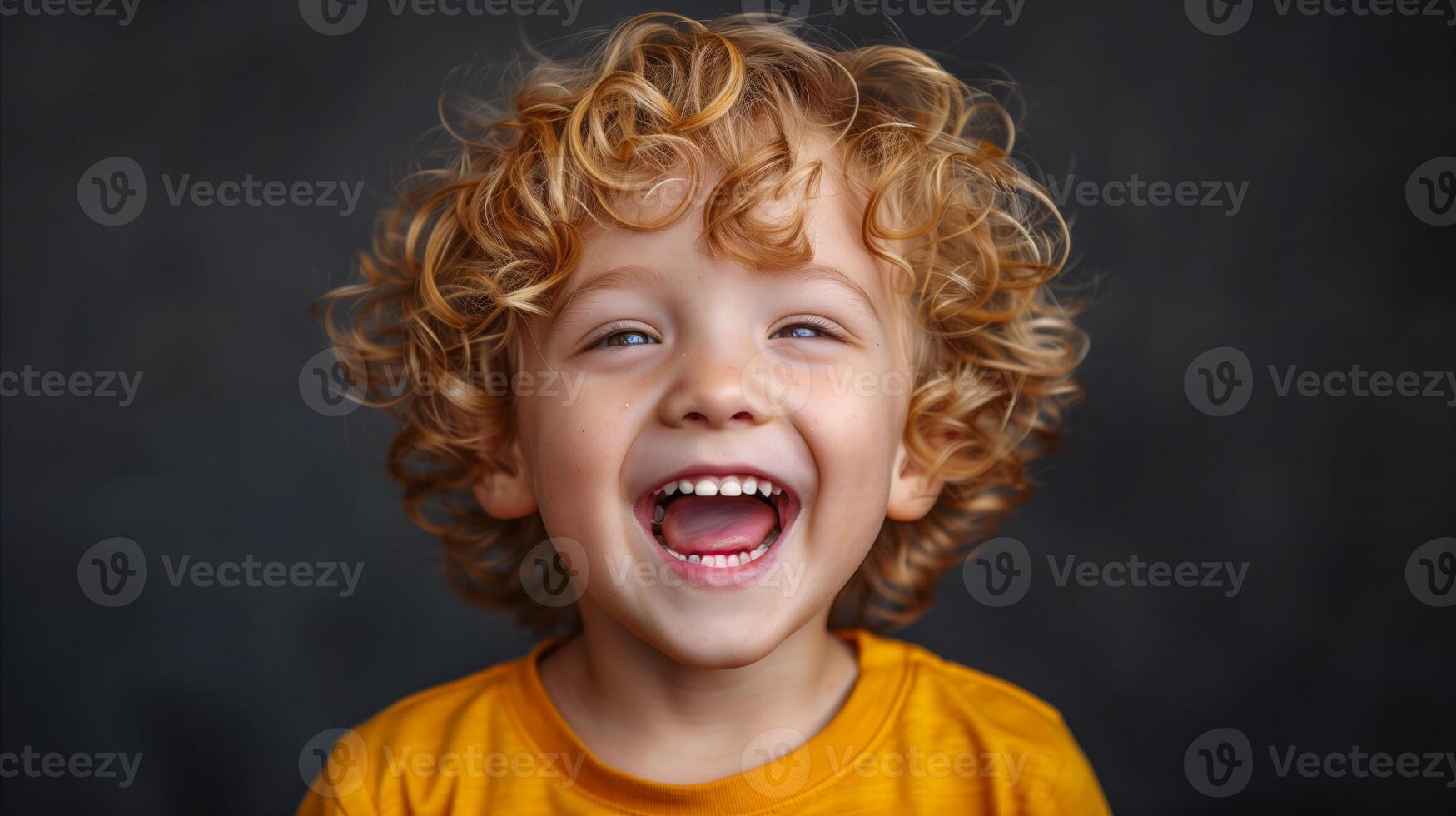 Cheerful Young Boy Laughing in Bright Yellow Shirt photo