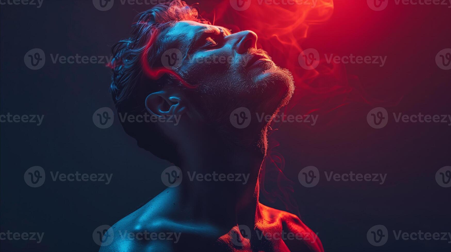 A man exhaling red smoke, creating a mysterious and intriguing atmosphere. photo