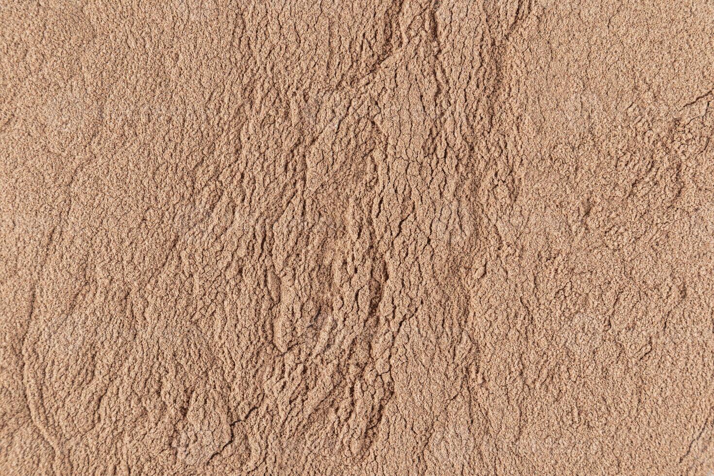Gorgeous texture of bronze loose powder. Close Up Image. Embossed texture. Cosmetic background. Layout for design. photo