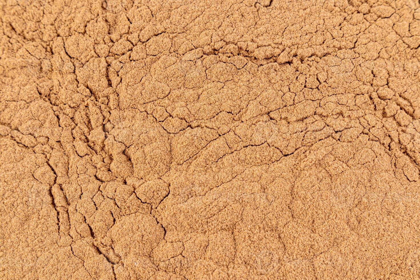 Gorgeous texture of bronze loose powder. Close Up Image. Embossed texture. Cosmetic background. Layout for design. photo