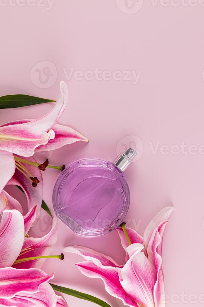 Elegant bottle of cosmetic spray or women's perfume on pastel vertical background with delicate lilies. A copy space. Blank layout for product. photo