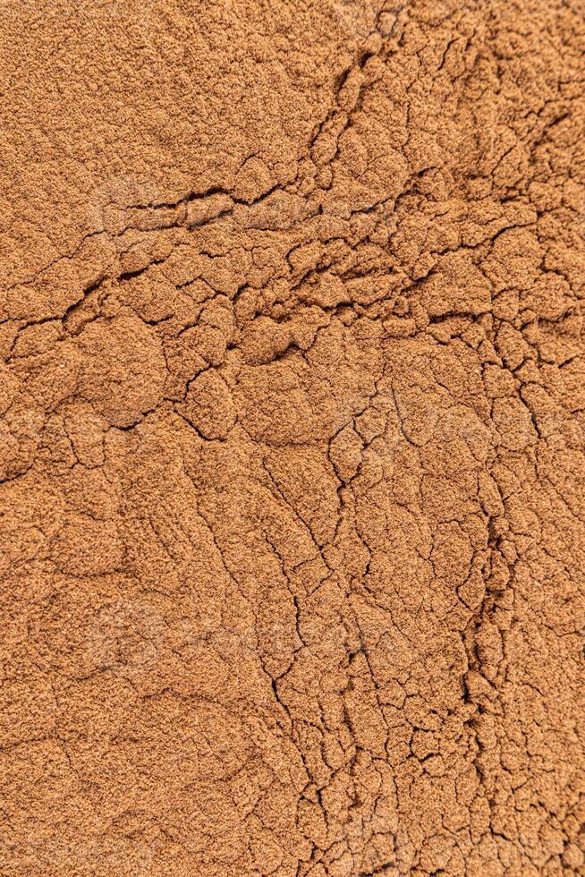 Gorgeous texture of bronze loose powder. Close Up Image. Embossed texture. Cosmetic background. Layout for design. product advertisement. Vertical. photo