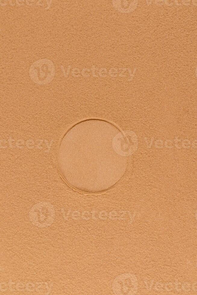 Vertical abstract background of brown or bronze texture cosmetic powder with round imprint from powder block. Layout for design. A copy space. photo