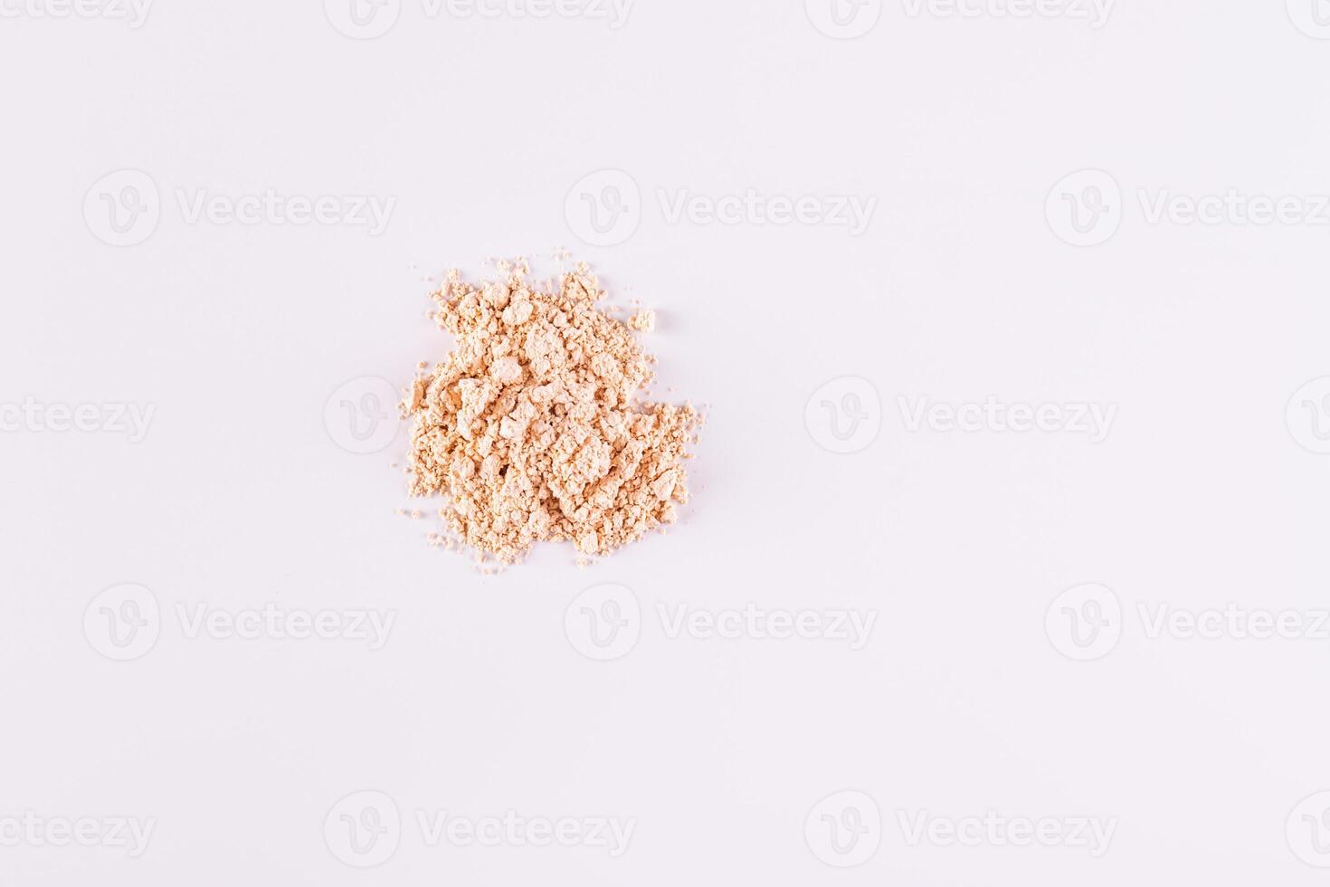 A pile of loose light powder on a white background. space for text. layout for your product. Color cosmetics texture concept. Top view. photo