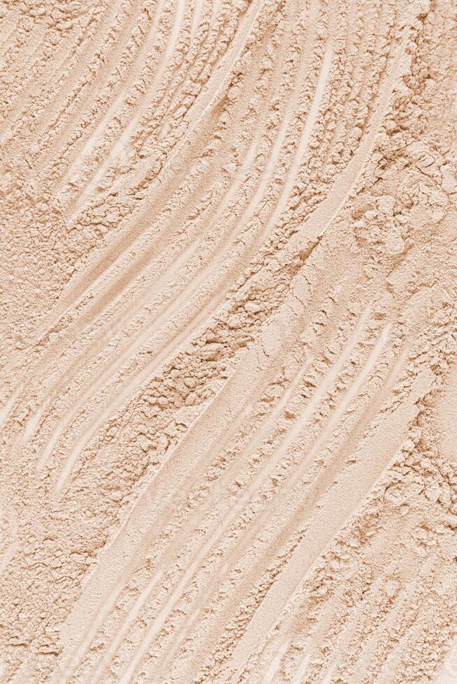 Chic abstract background of loose powder in natural tone. Vertical view. A copy of the space. Cosmetic background. Layout for design. photo