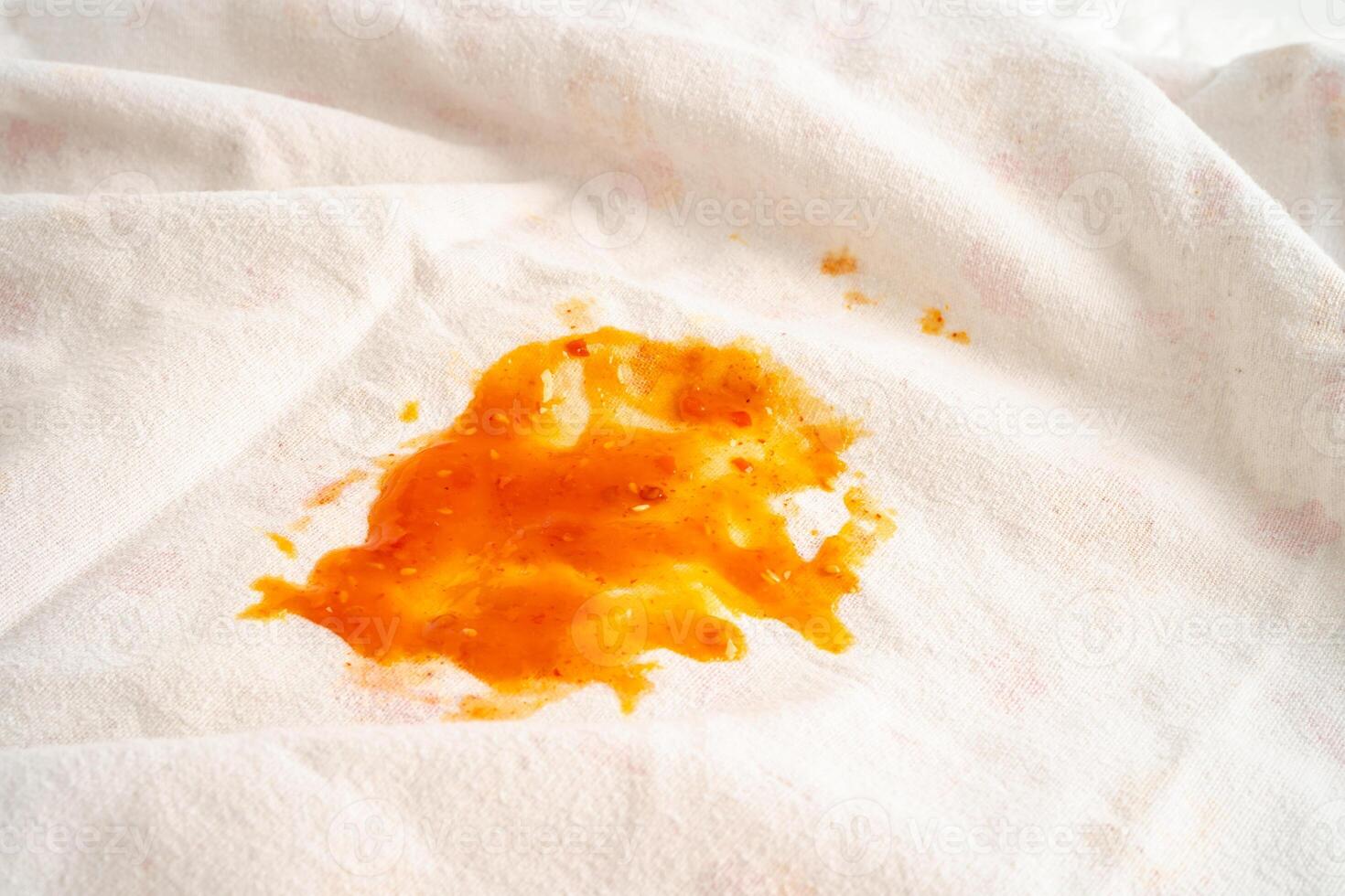 Dirty tomato sauce stain or ketchup on cloth to wash with washing powder, cleaning housework concept. photo