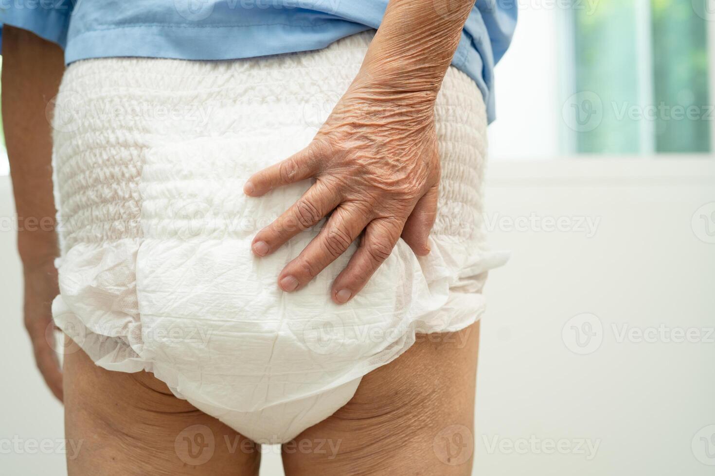 Asian senior woman patient wearing incontinence diaper in hospital, healthy strong medical. photo