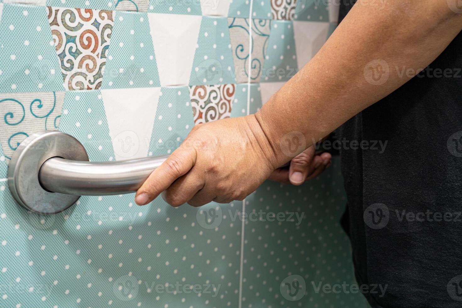 Asian elderly woman use toilet bathroom handle security, healthy strong medical concept. photo