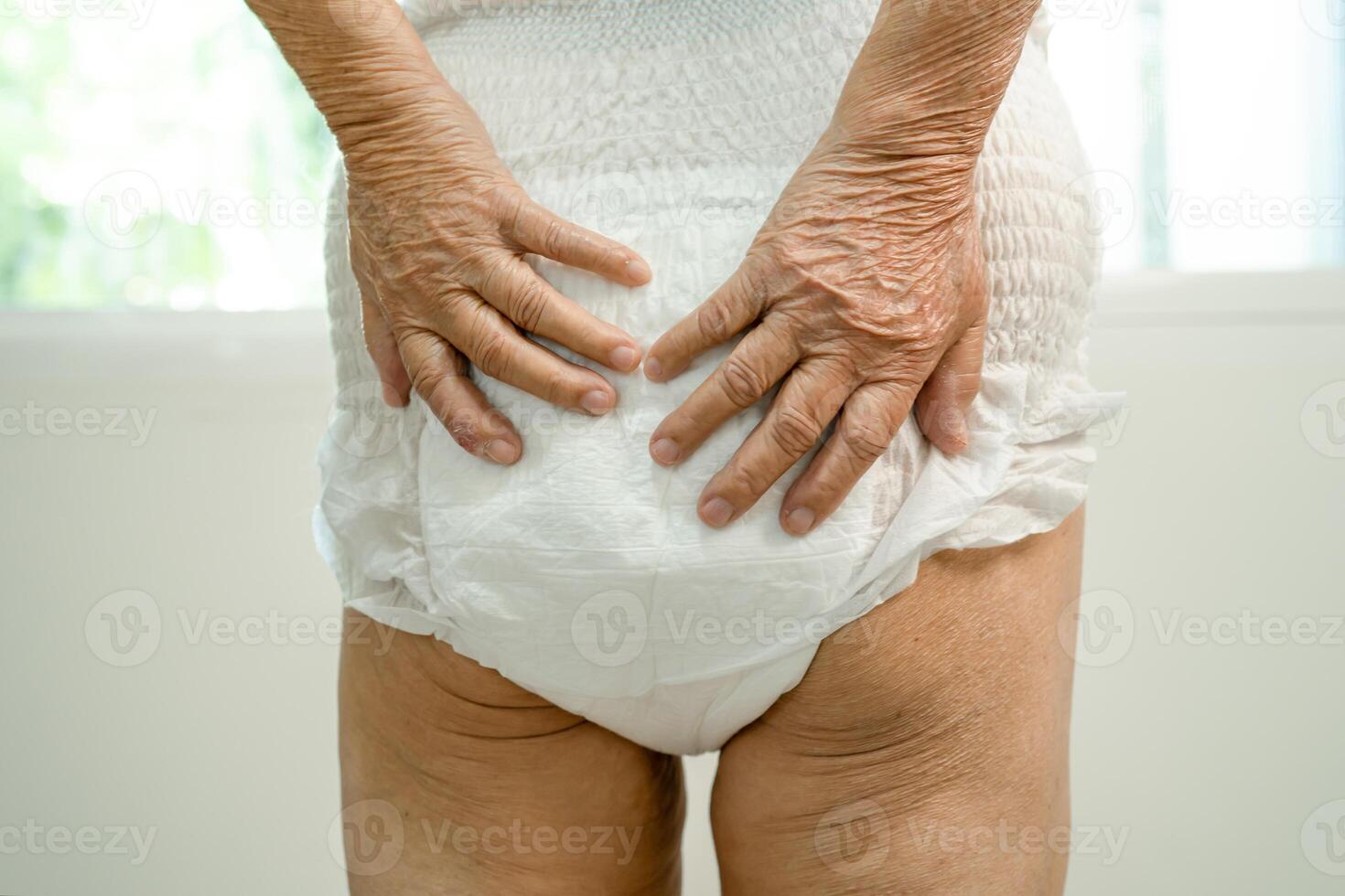 Asian senior woman patient wearing incontinence diaper in hospital, healthy strong medical concept. photo