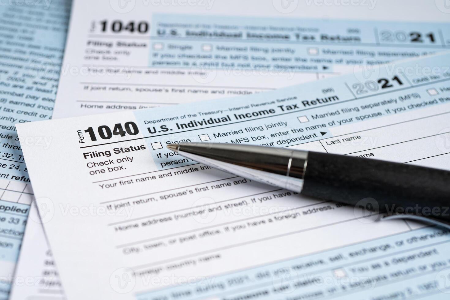 Tax Return form 1040 with pen, U.S. Individual Income. photo