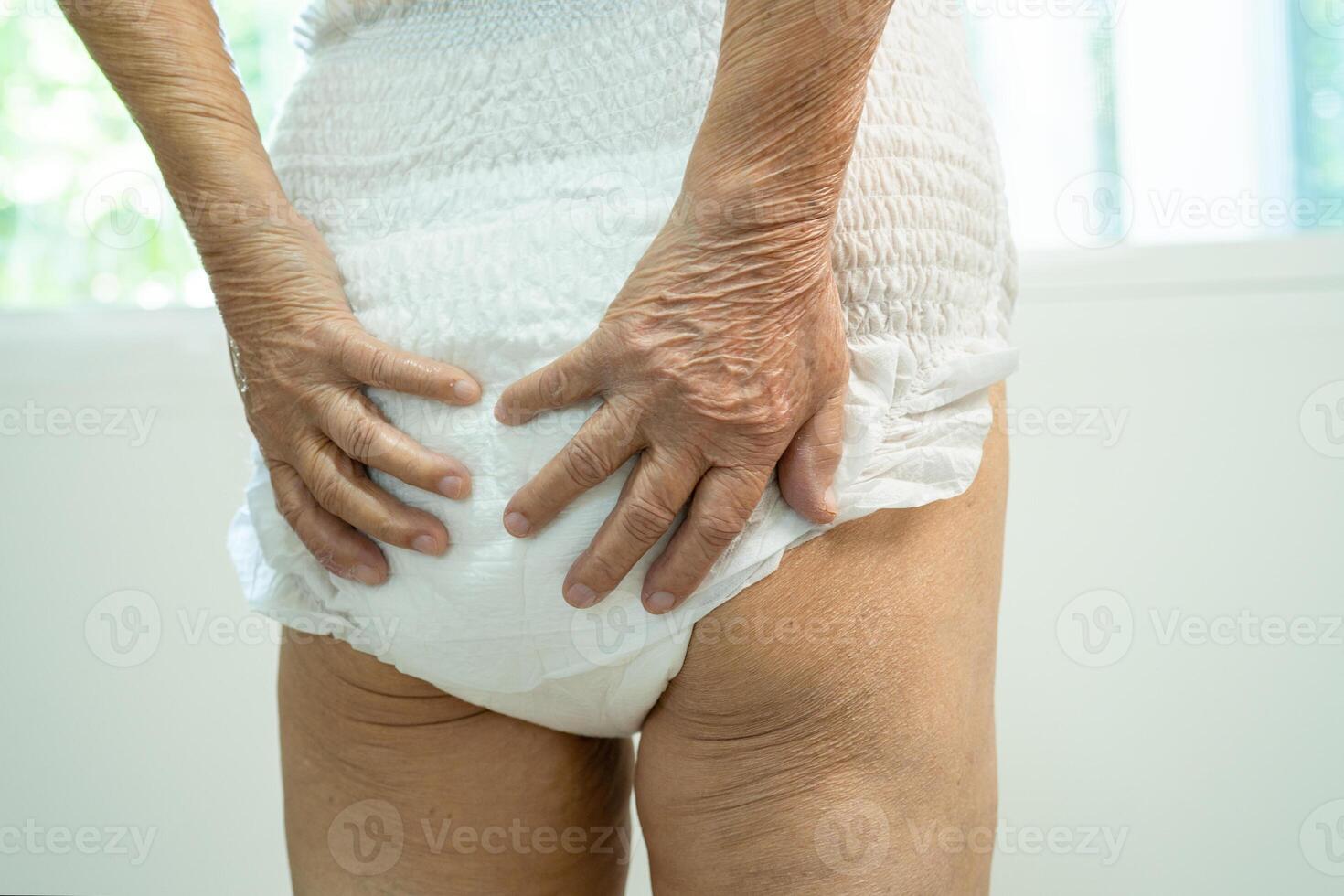 Asian senior woman patient wearing incontinence diaper in hospital, healthy strong medical concept. photo