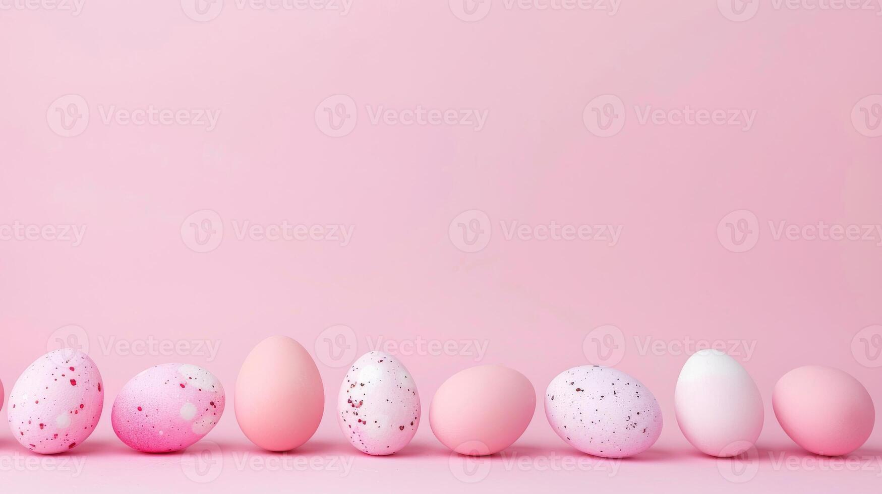 Row of pink and white eggs on pink background photo