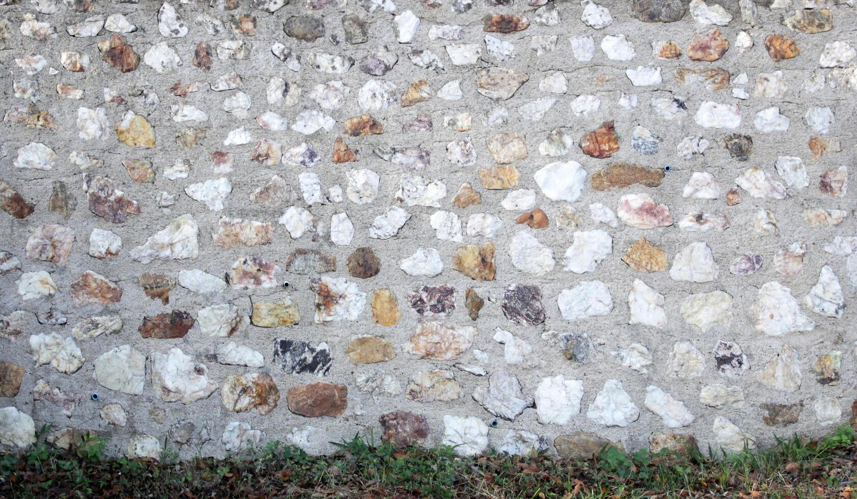 Concrete wall and gravel background photo