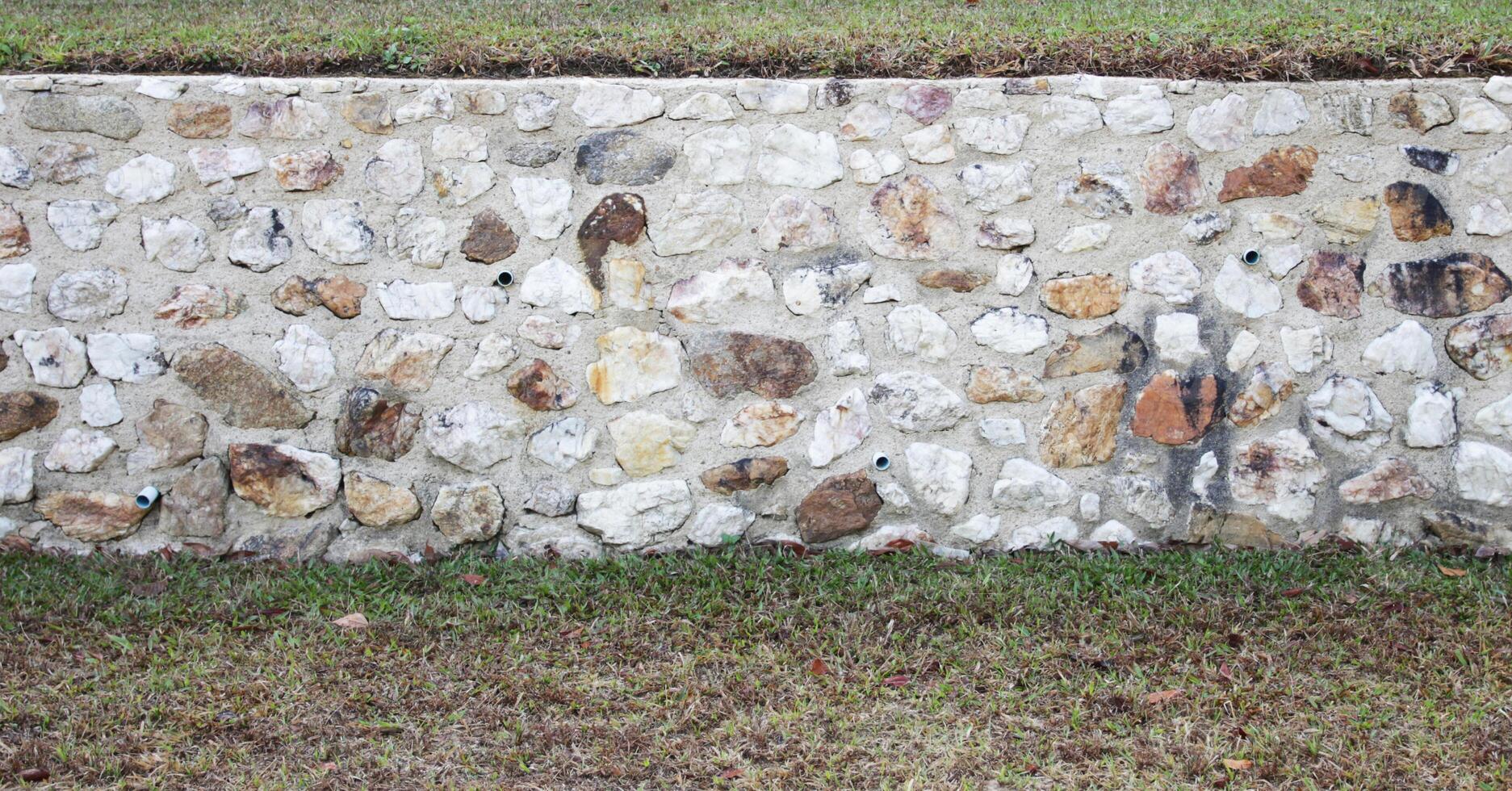 Concrete wall and gravel background photo