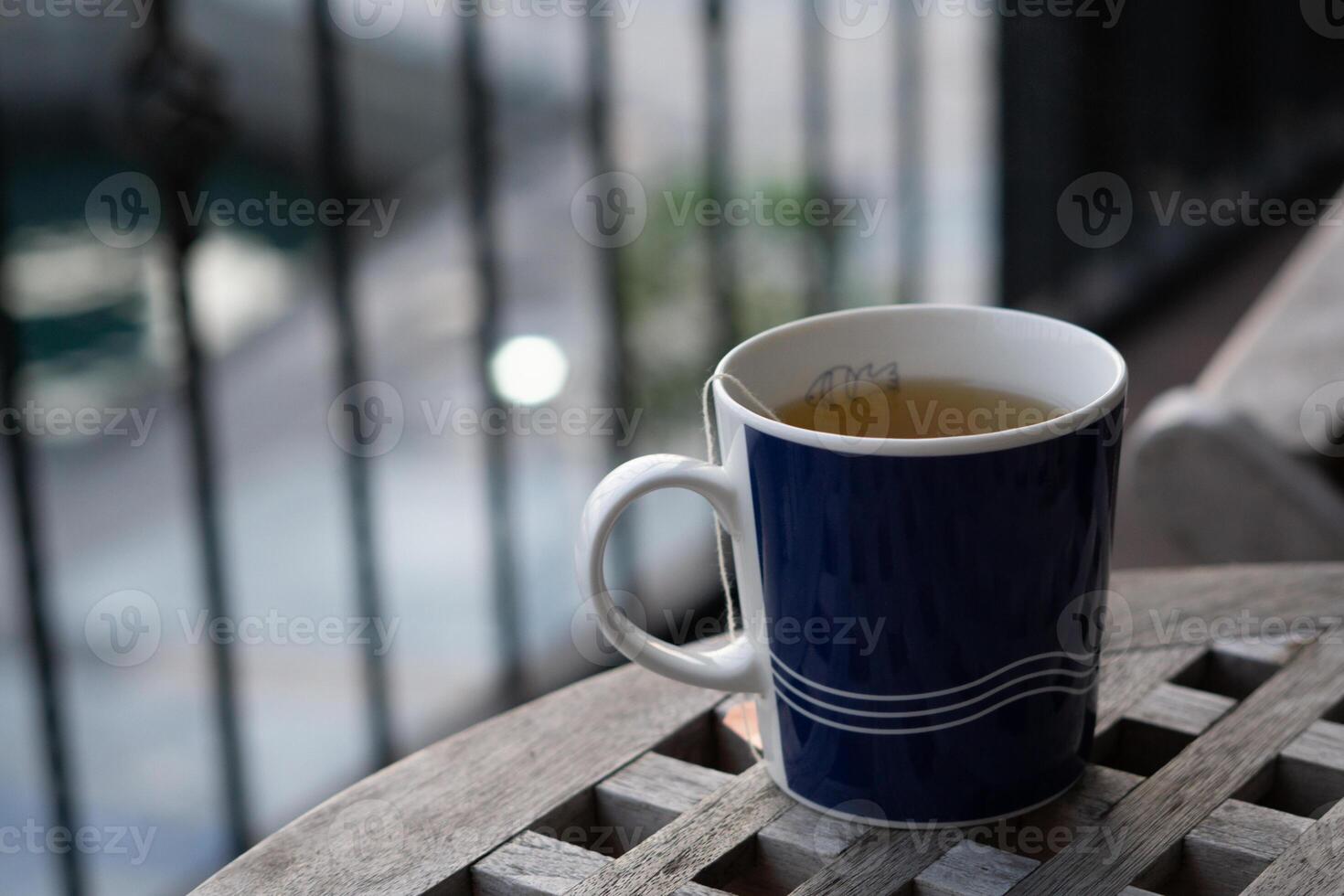 Morning Close-Up Tea in Mug, Sunrise Bokeh Overlooking Harbour Views in Taiwan photo