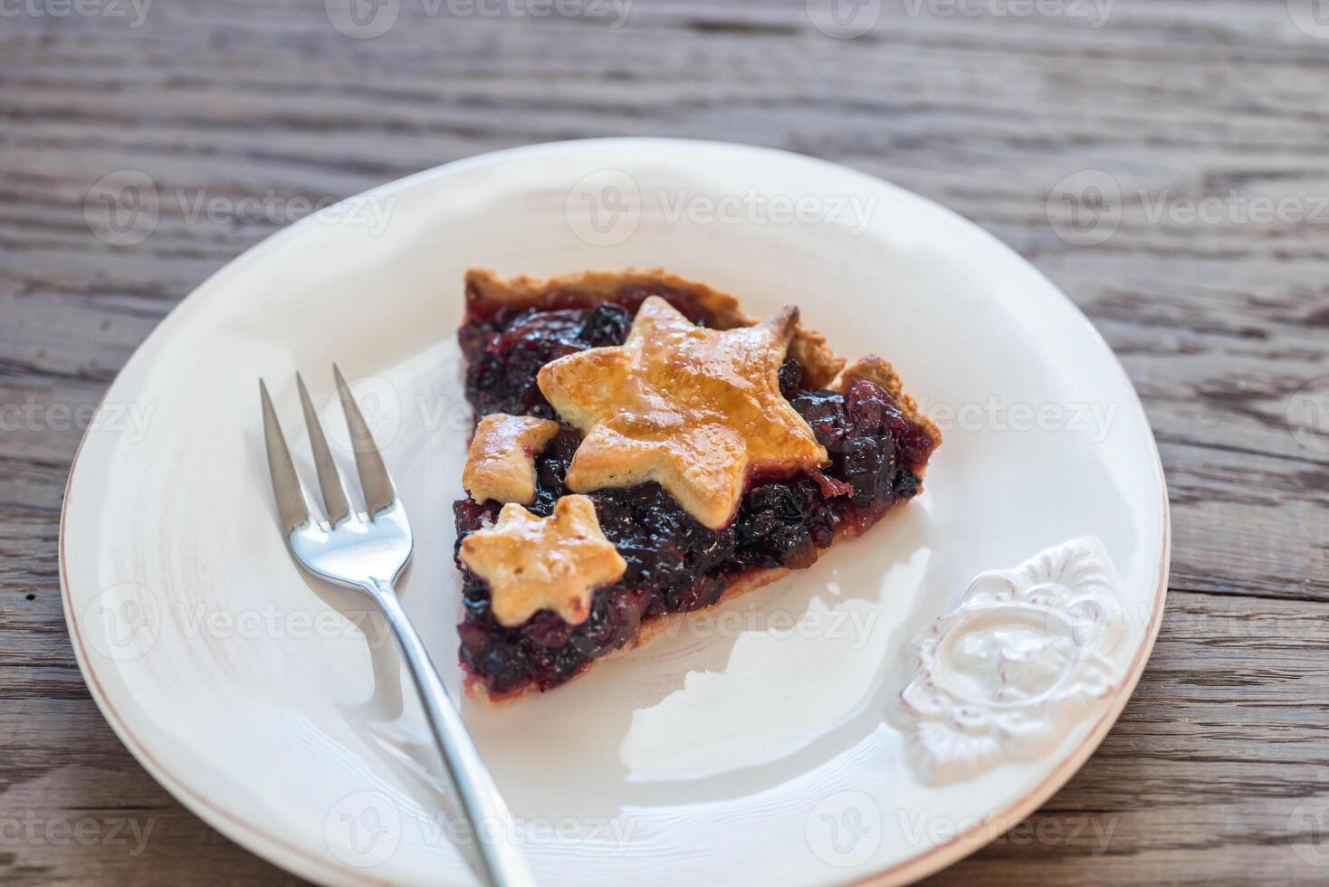 Portion of mince pie on the wooden background photo