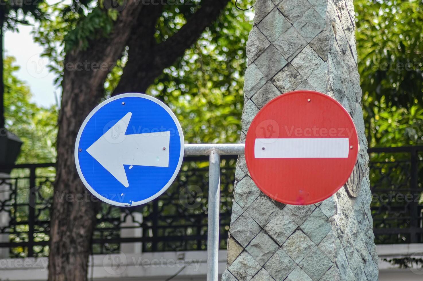 Road signs indicate a one-way street photo