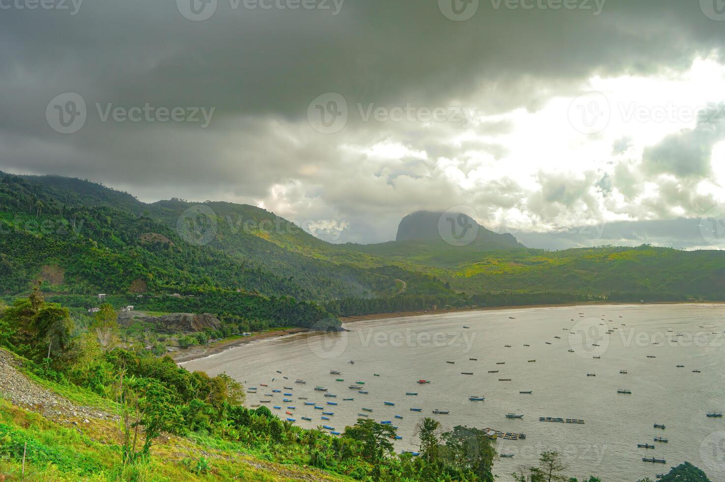 natural scenery of gemah beach and popoh bay facing the south sea of java island or indian ocean decorated with some mountains photo