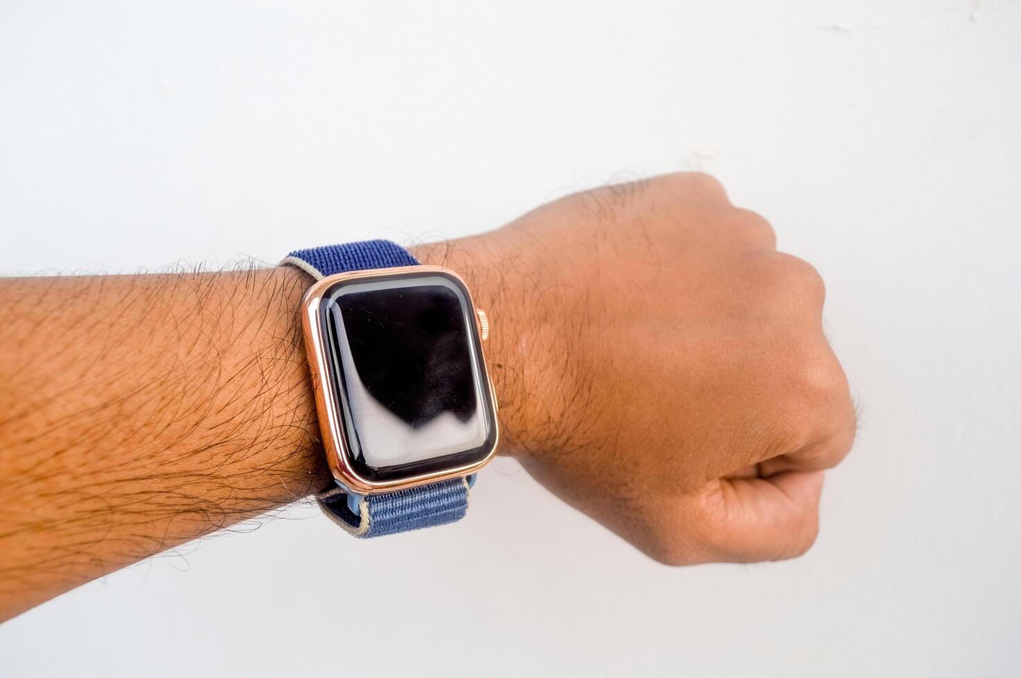 man's hand wearing a smart watch photo