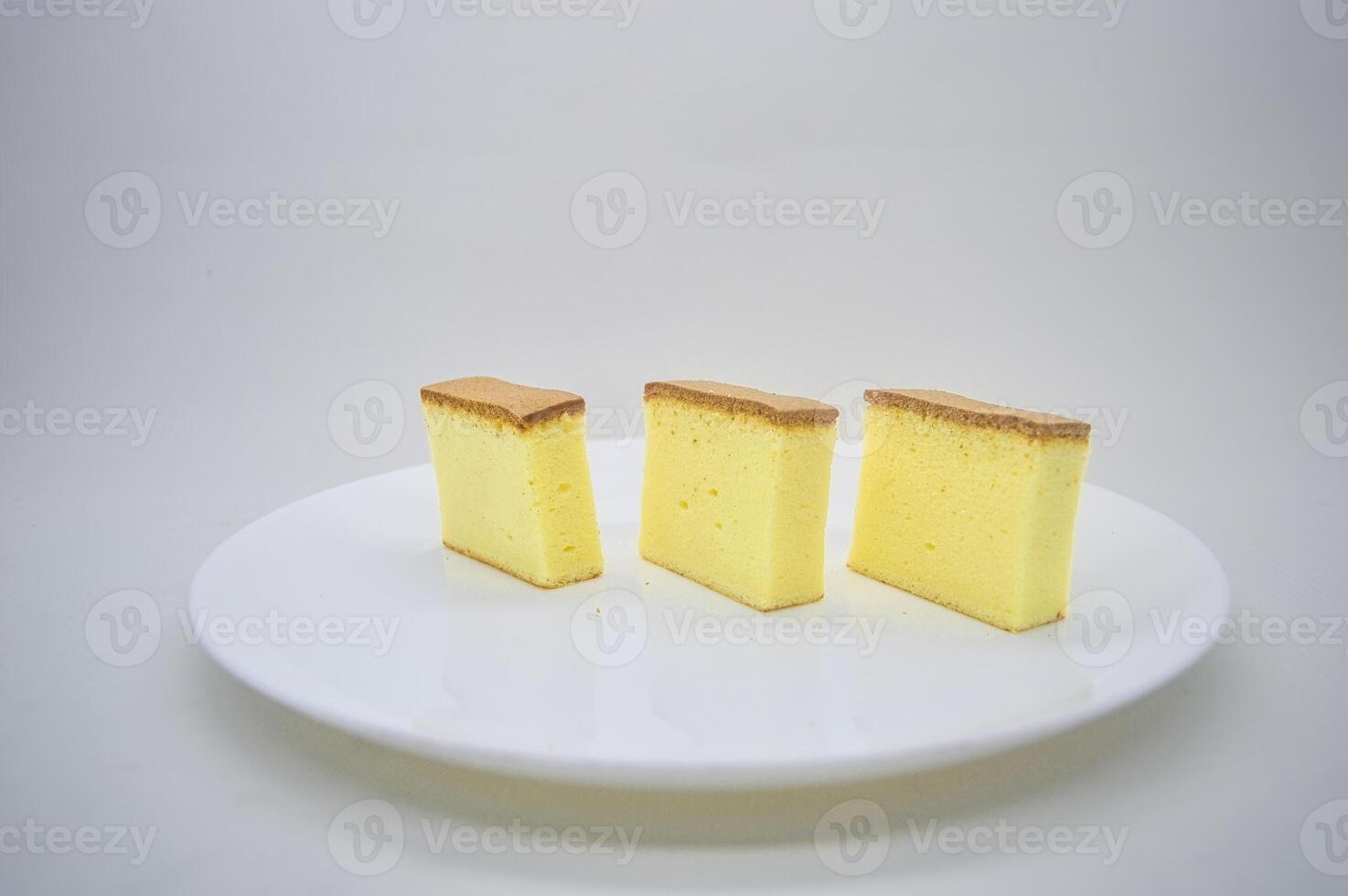 three slices of cheese cake on a white plate with a plain background photo