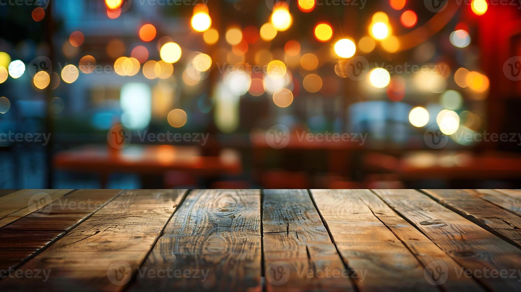 Image of wooden table in front of abstract blurred restaurant lights background, photo