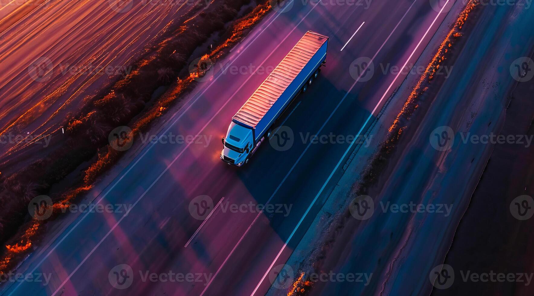 Long haul container truck carrying commercial cargo delivery between cities on a freeway photo
