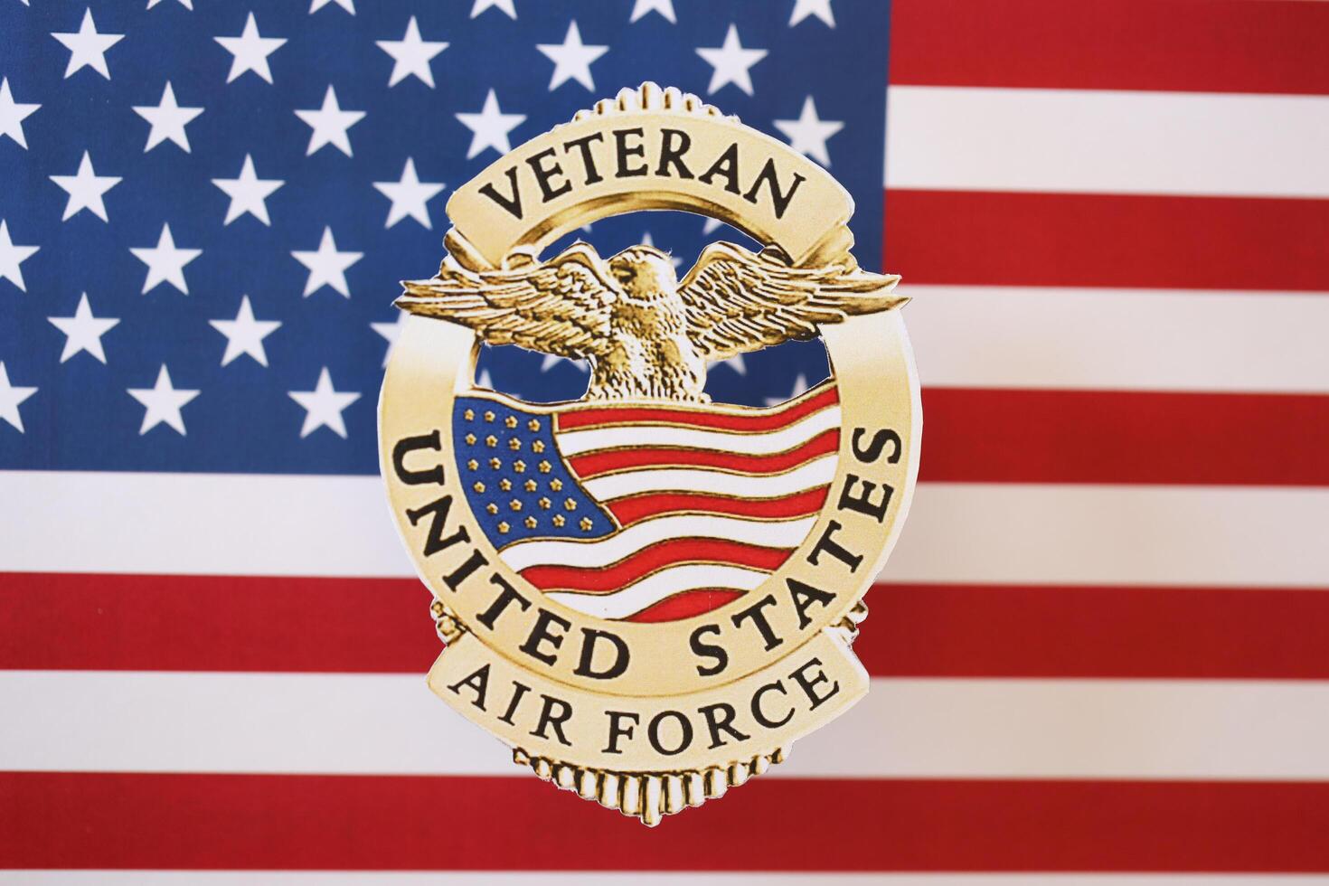 KYIV, UKRAINE - MARCH 9, 2024 US Air Force Veteran badge on United States of America flag photo