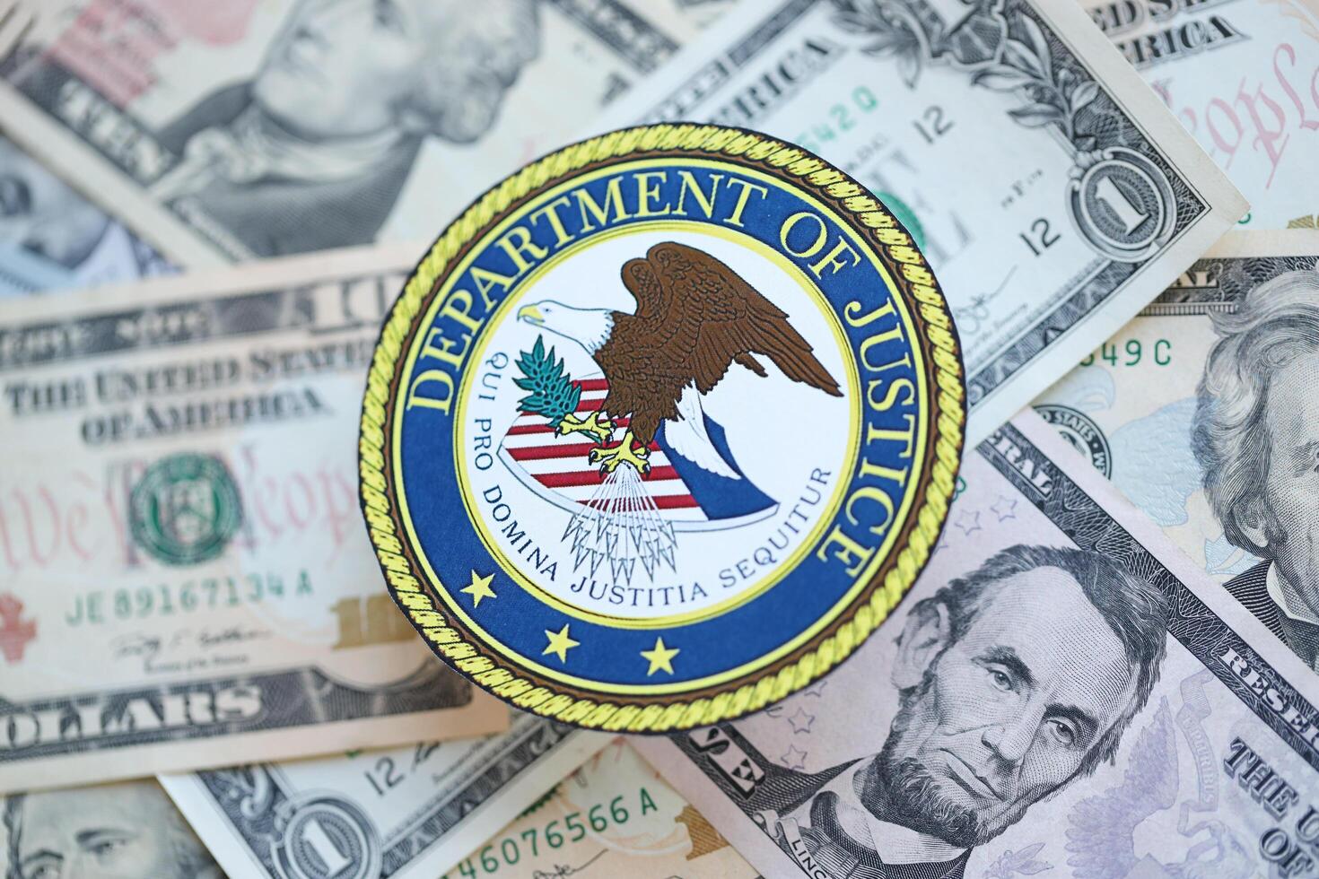 KYIV, UKRAINE - MARCH 9, 2024 US Department of Justice seal on many US dollar bills photo