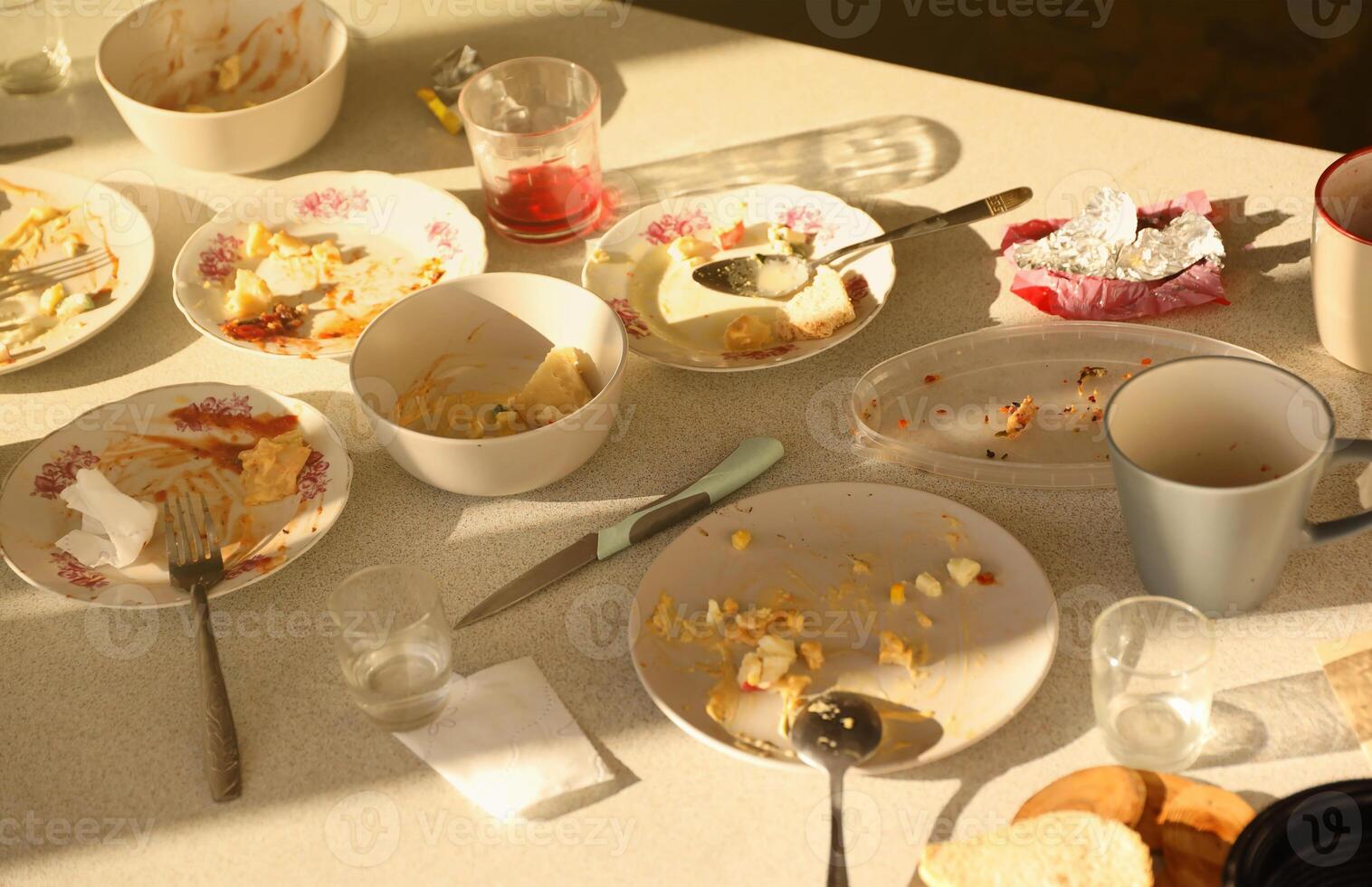 Empty dirty plates with spoons and forks on the table after meal. Banquet ending concept. Unwashed dishes photo