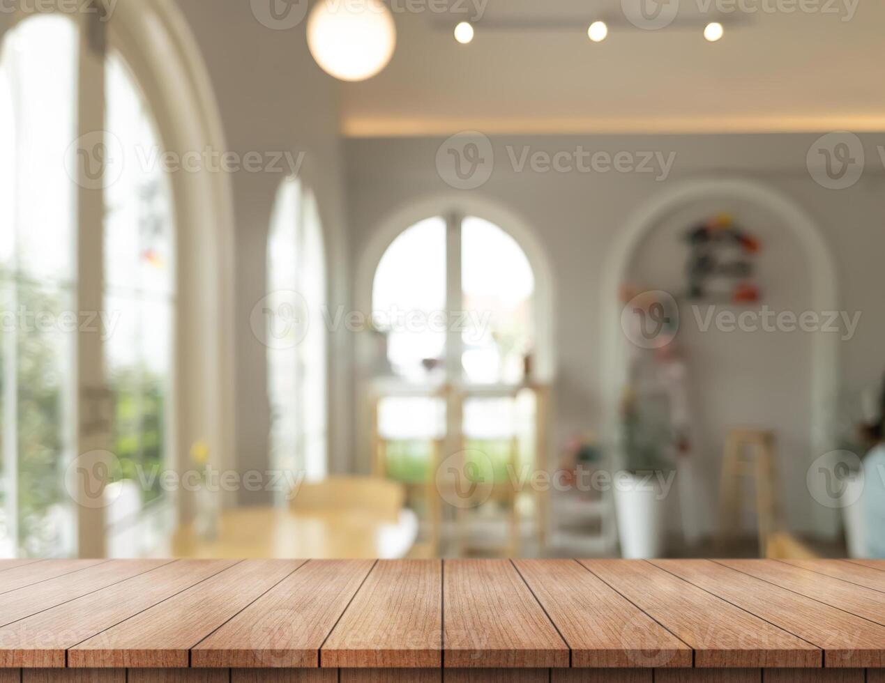 Empty wooden table top with lights bokeh on blur restaurant background. photo