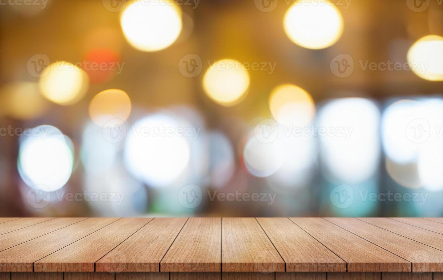 Empty wooden table top with lights bokeh on blur restaurant background. photo