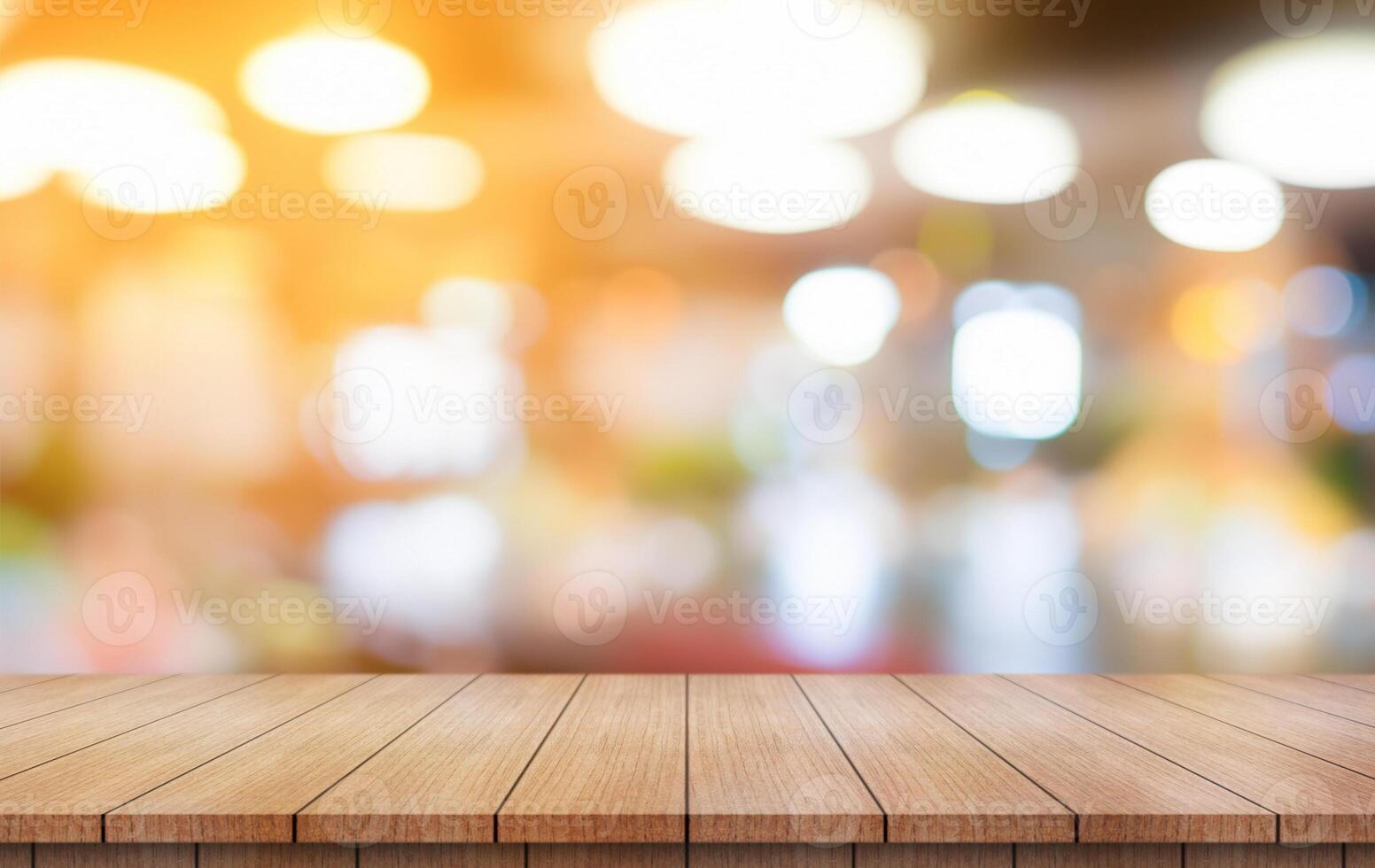 Empty wooden table top with lights bokeh on blur restaurant background. photo