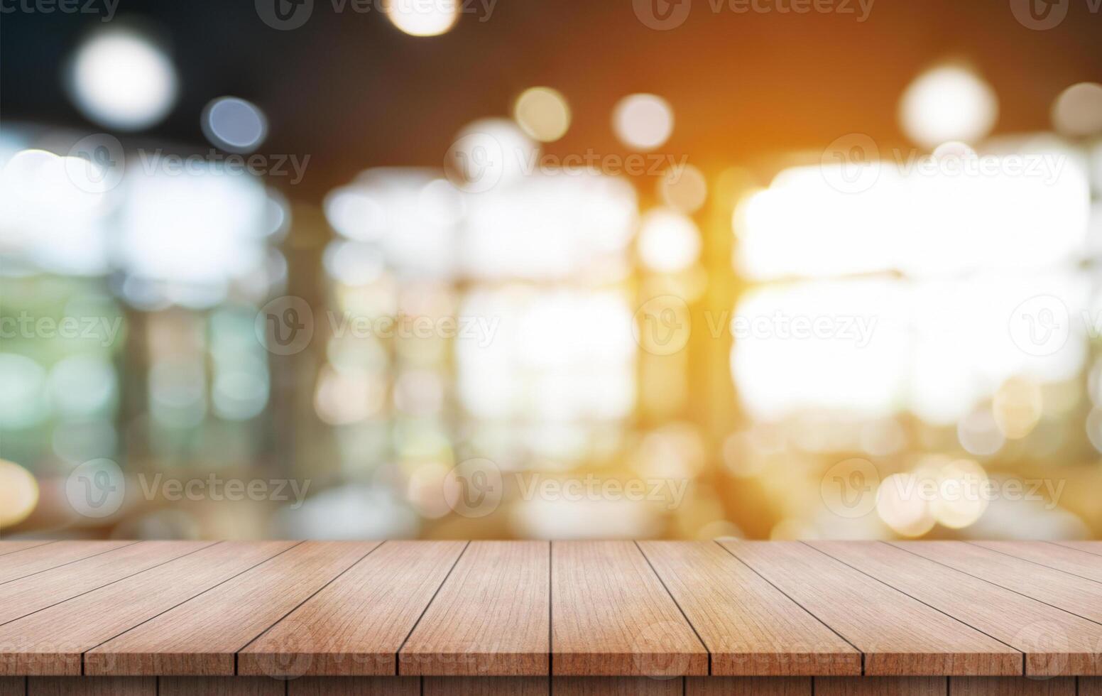 Empty wooden table top with lights bokeh on blur restaurant background. photo