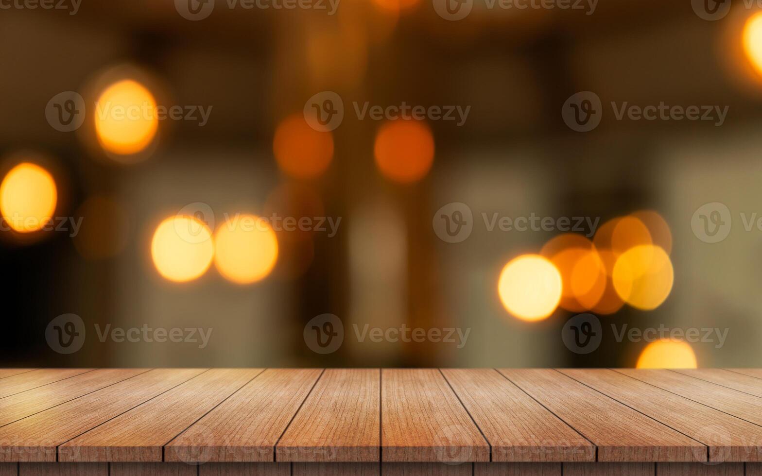 Empty wooden table top with lights bokeh on blur restaurant background. photo