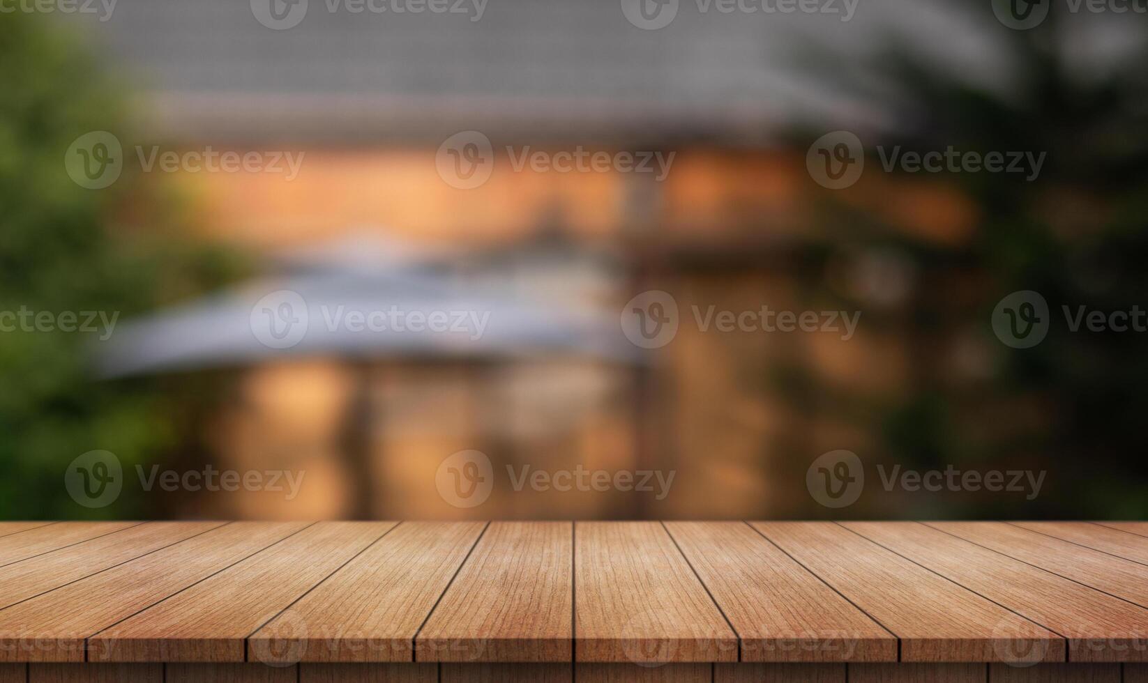 Empty wooden table top with lights bokeh on blur restaurant background. photo