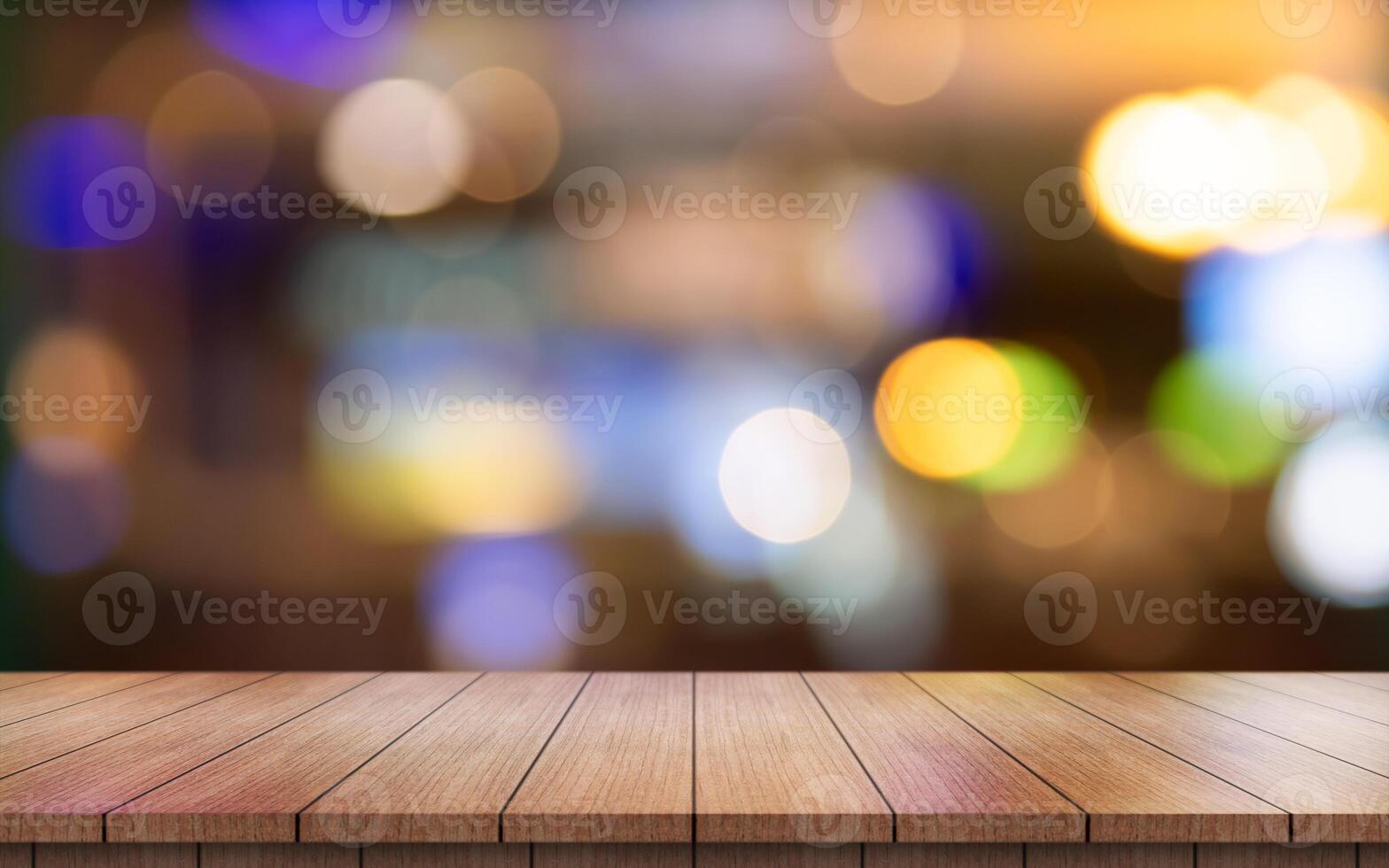 Empty wooden table top with lights bokeh on blur restaurant background. photo